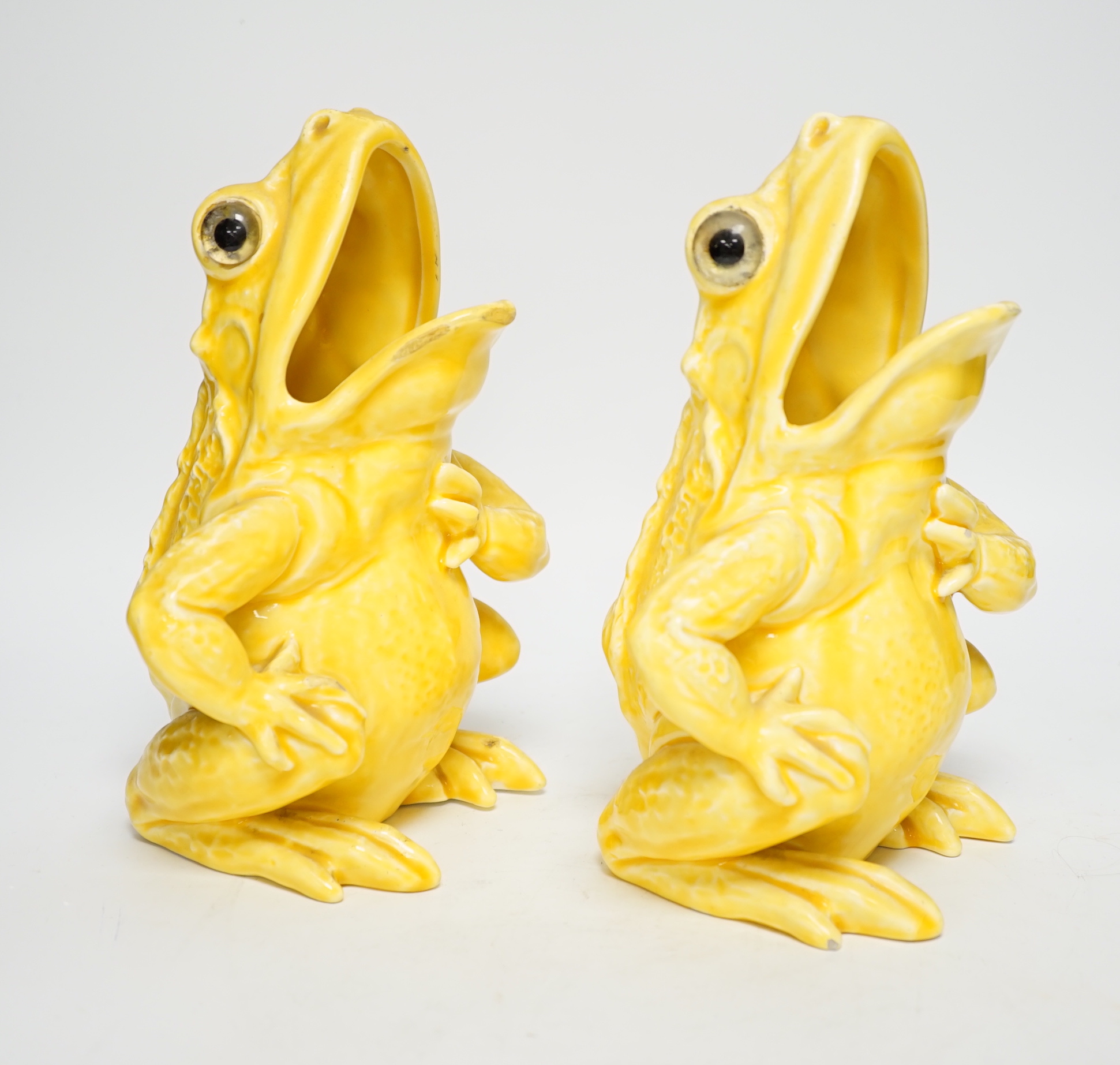 A pair of Continental yellow glazed pottery frogs, 21.5cm